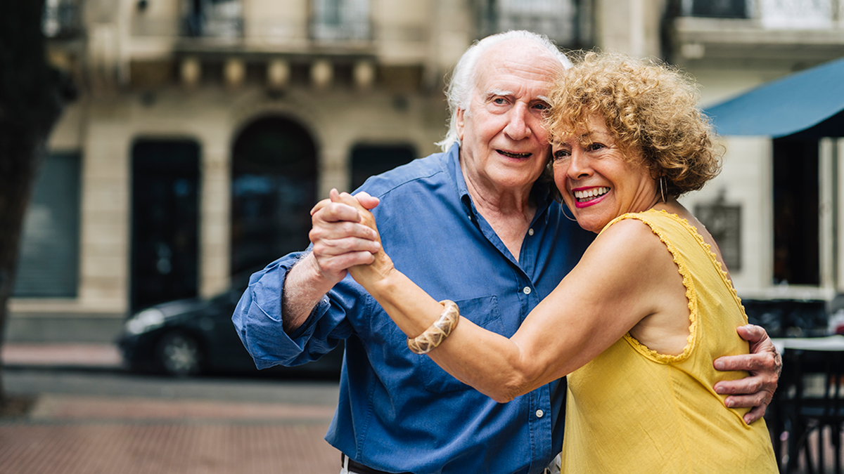 senior couple dance together