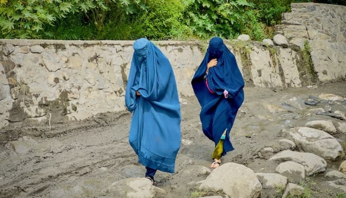 Afghan women in burqas walk towards a safer place after their house was damaged following a deadly magnitude 6 earthquake that struck Afghanistan on Sunday, at Lulam village, in Nurgal district, Kunar province, Afghanistan, September 3. — Reuters