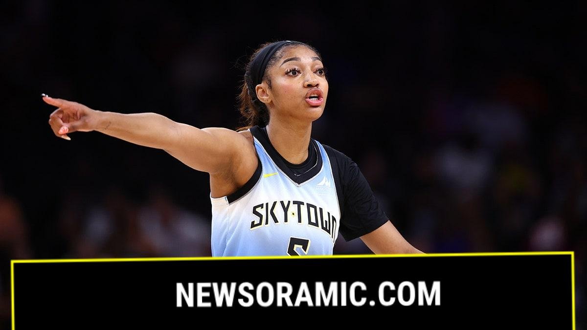 Angel Reese points on court