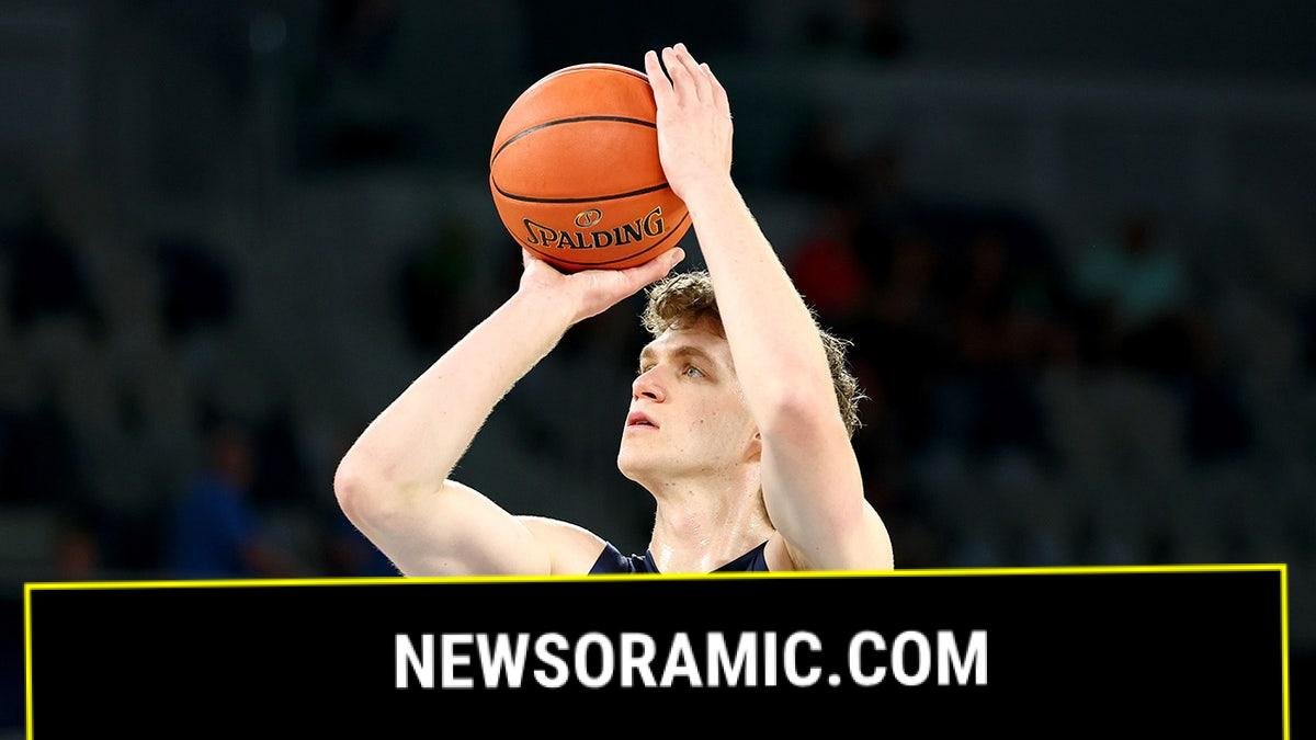 Ben Griscti warms up before a basketball game