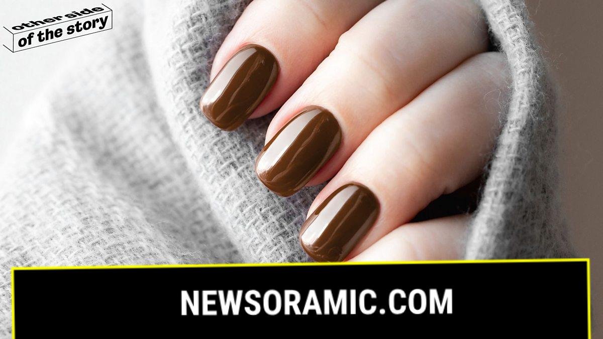 An image of a hand beneath a UV light as part of the gel nails setting process