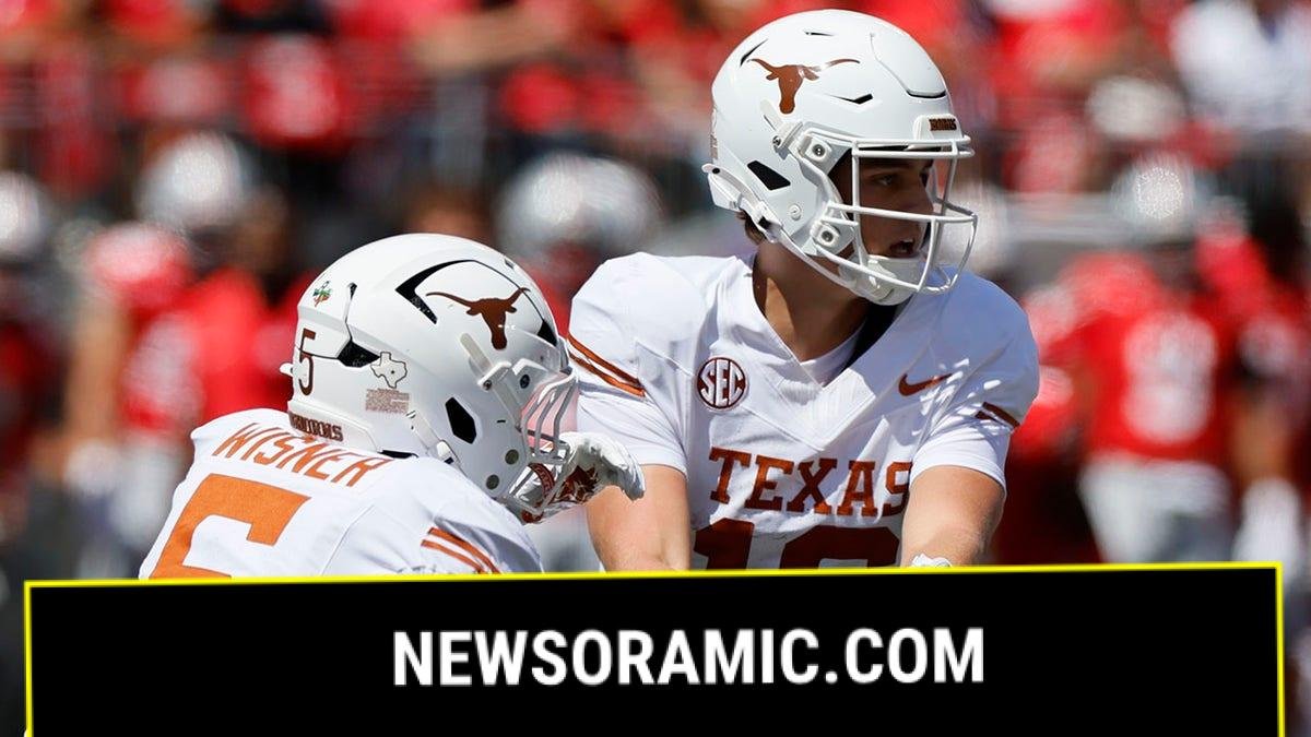 Arch Manning gives the ball to Quintrevion Wisner