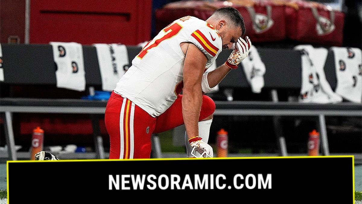 Travis Kelce kneels